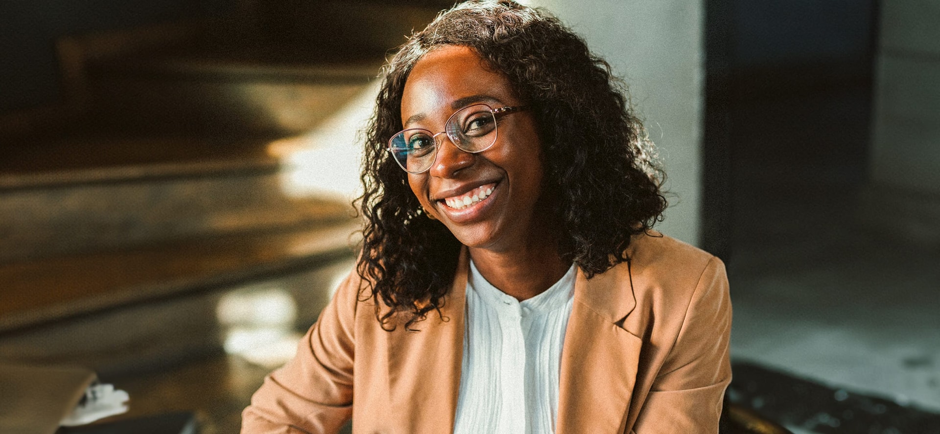 woman smiling at a desk