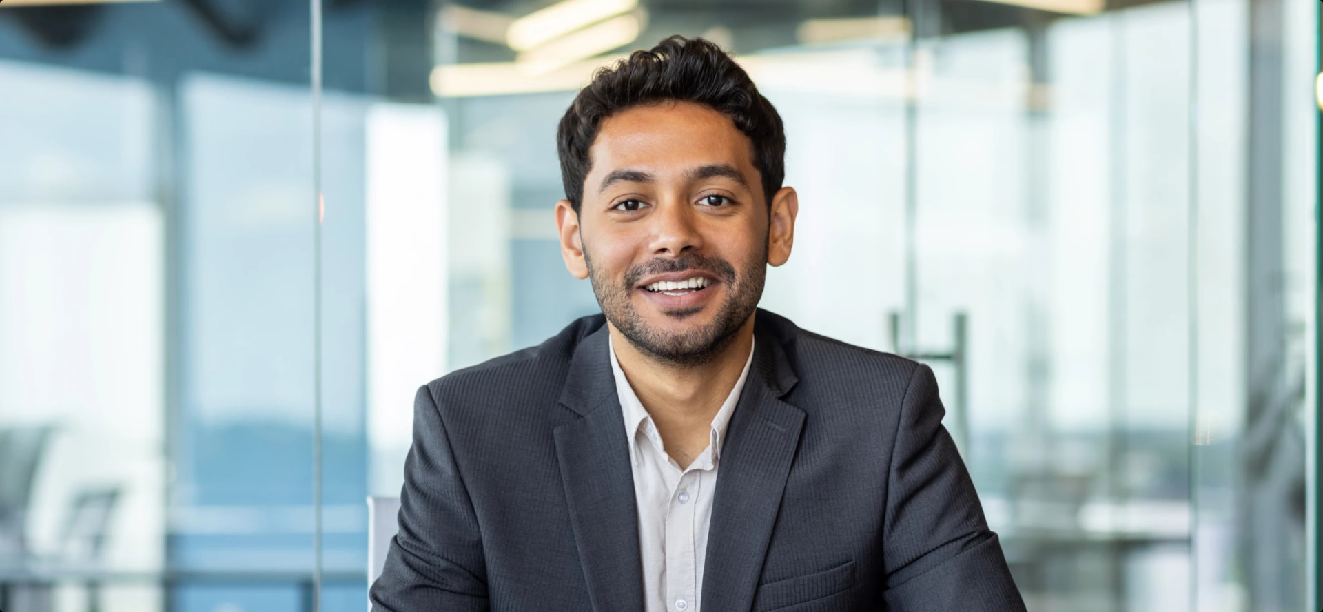 young professional man in suit in board room