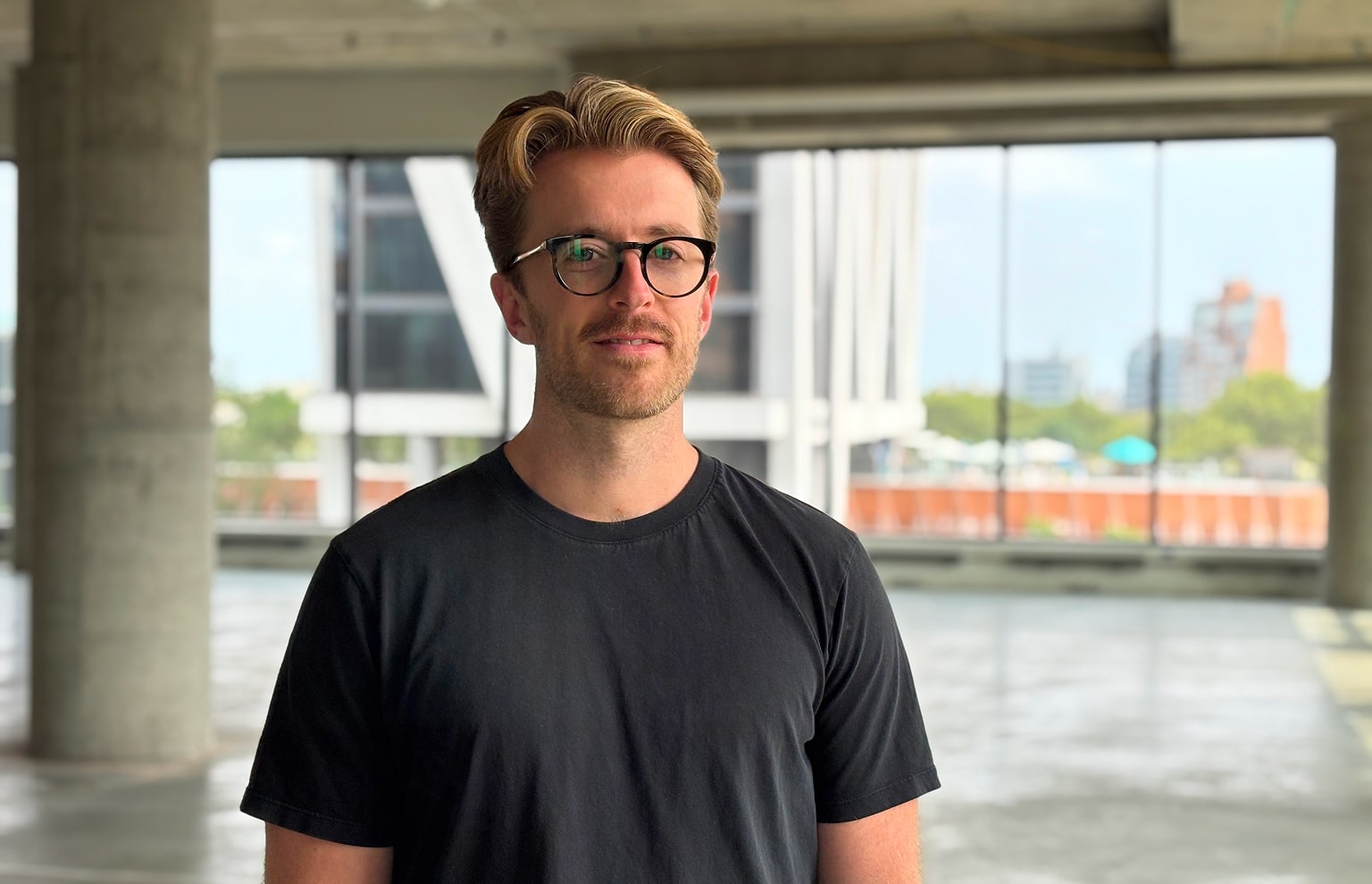 mike barbosa, CEO of OatFi, standing in a conference room