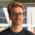 mike barbosa, CEO of OatFi, standing in a conference room