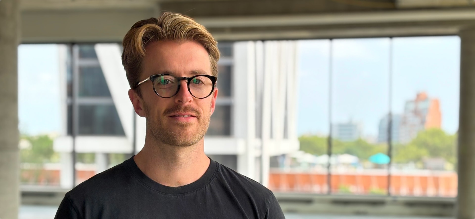 mike barbosa, CEO of OatFi, standing in a conference room