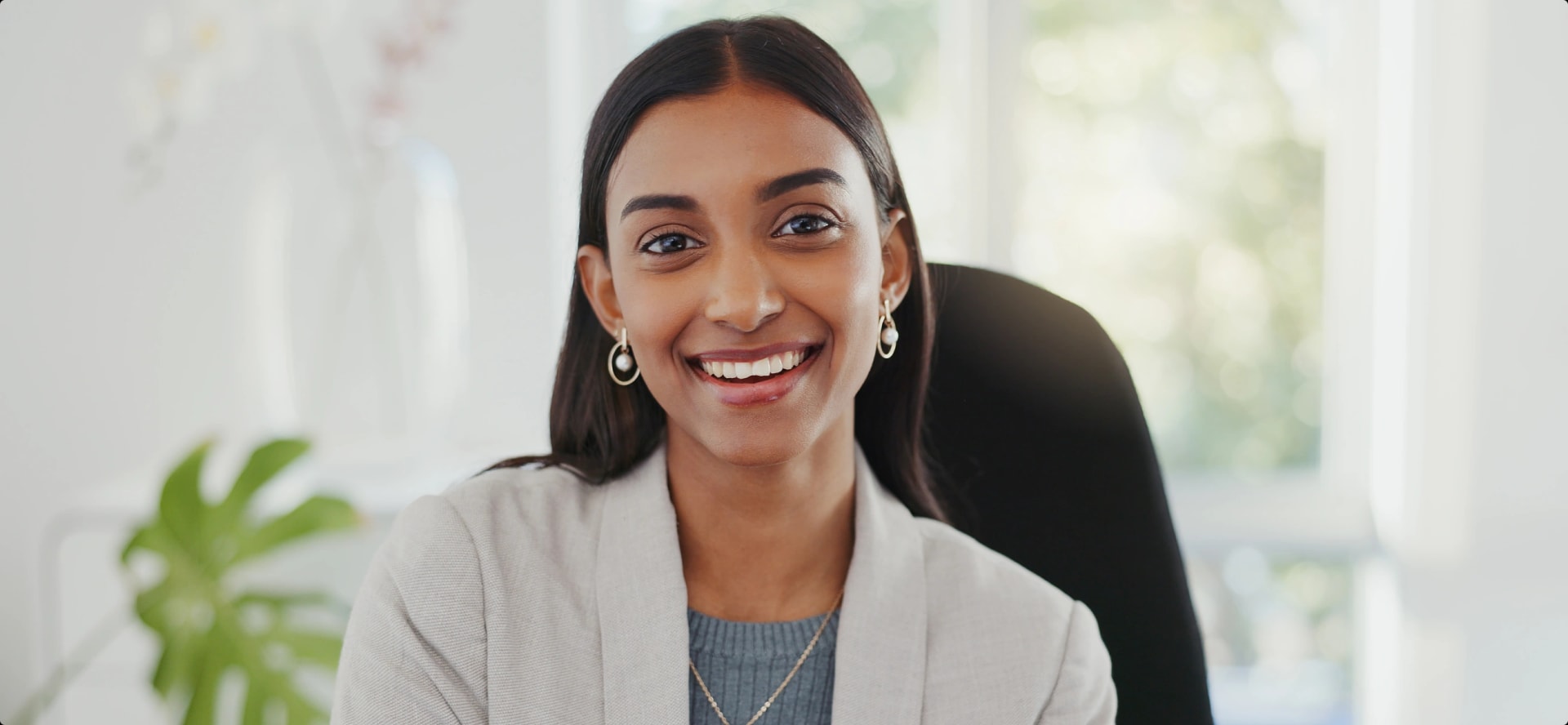 young professional woman sitting at a chair in a home office